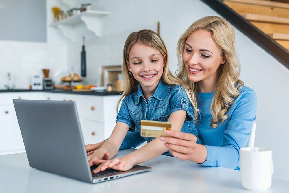 Mother and Daughter holding a credit card